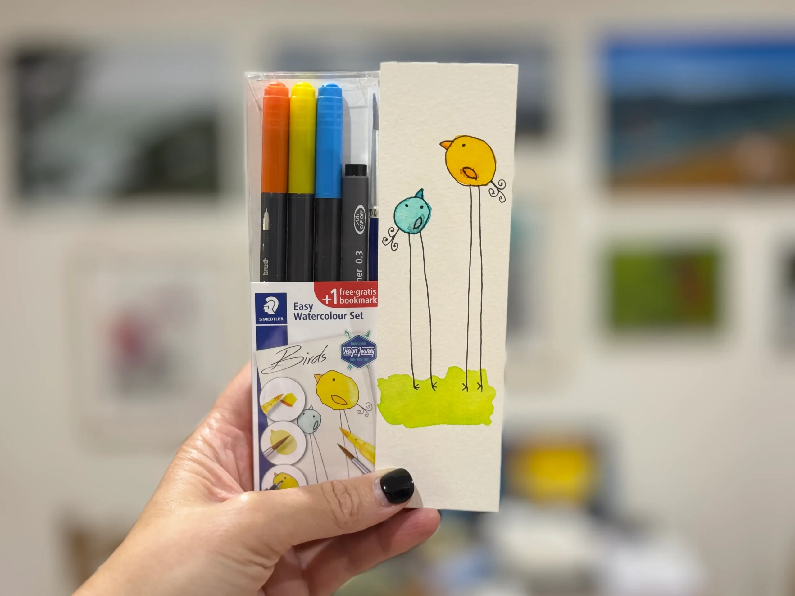 A drawing kit next to an artwork created with it